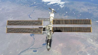 The International Space Station photographed against the Rio Negro, Argentina, from the shuttle orbiter Atlantis, February 16, 2001. Atlantis' primary mission was to deliver the Destiny laboratory module, visible at the leading end of the station.