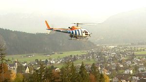 View Christoph Kessler of the German Space Agency working on a helicopter's rotor blades to reduce the noise