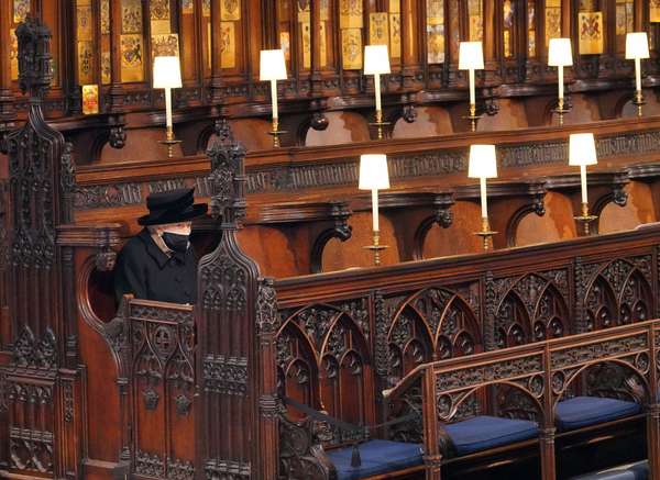 Queen Elizabeth II takes her seat during the funeral of Prince Philip, Duke of Edinburgh, at St. George&#39;s Chapel at Windsor Castle on April 17, 2021 in Windsor, England. Prince Philip of Greece and Denmark was born June 10, 1921, in Greece. He served in the British Royal Navy and fought in WWII. He married the then Princess Elizabeth on November 20, 1947 and was created Duke of Edinburgh, Earl of Merioneth, and Baron Greenwich by King VI. He served as Prince Consort to Queen Elizabeth II until his death on April 9 2021, months short of his 100th birthday. His funeral takes place today at Windsor Castle with only 30 guests invited due to Coronavirus pandemic restrictions. (British royalty)