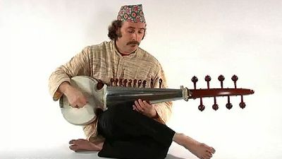 Watch a man playing the sarod, a stringed instrument of Hindustani music